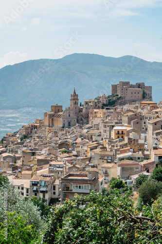 Caccamo, Sicily, Italy. View of popular hilltop medieval town with impressive Norman castle and surrounding countryside.Italian landscape.Picturesque village on hill with mountains in background.