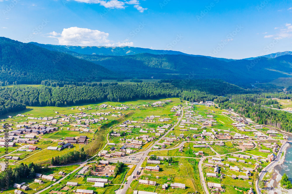Beautiful Hemu Village with natural scenery in Xinjiang,green mountain and forest with rivers.Hemu Village is a famous travel destination in China.Aerial view.