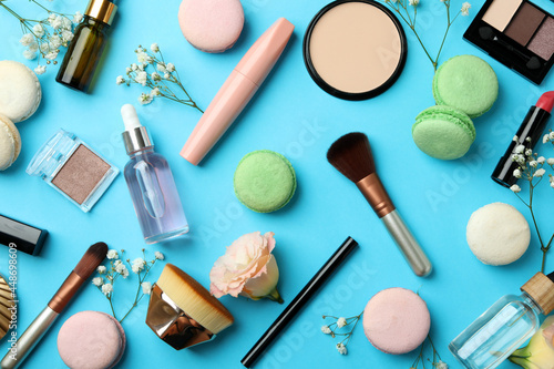 Female accessories and macaroons on blue background