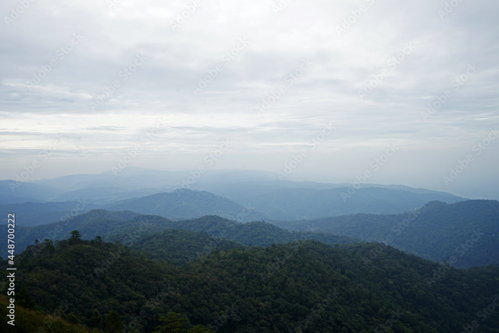 Natural landscape of green mountain range with cloudy blue sky Natural landscape of green mountain range with cloudy blue sky