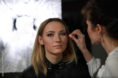 Young girl with a make-up artist