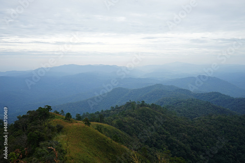 Natural landscape of green mountain range with cloudy blue sky