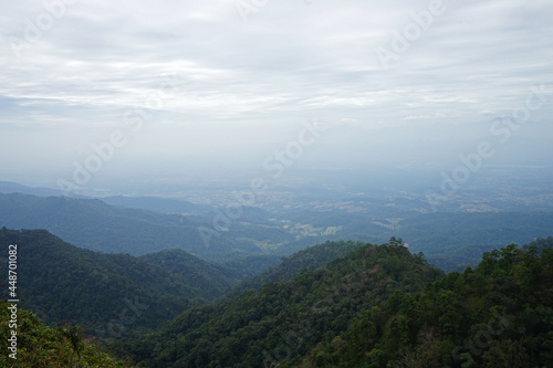 Natural landscape of green mountain range with cloudy blue sky © chettarin