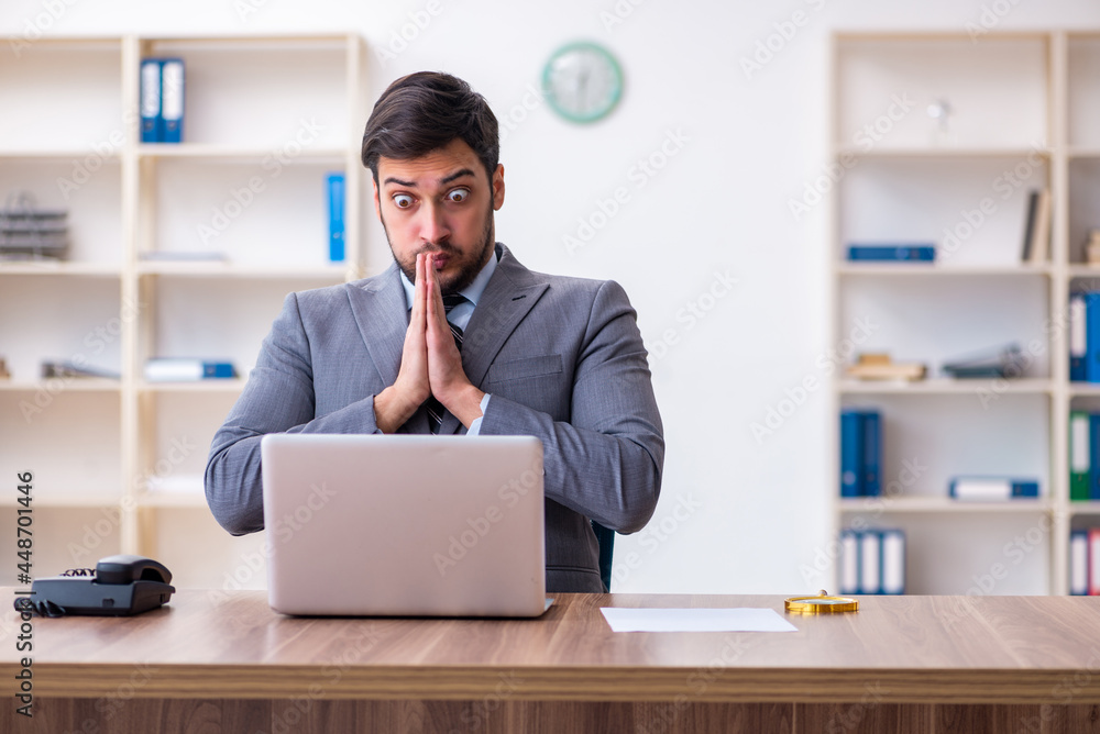Young handsome businessman employee working in the office Young handsome businessman employee working in the office