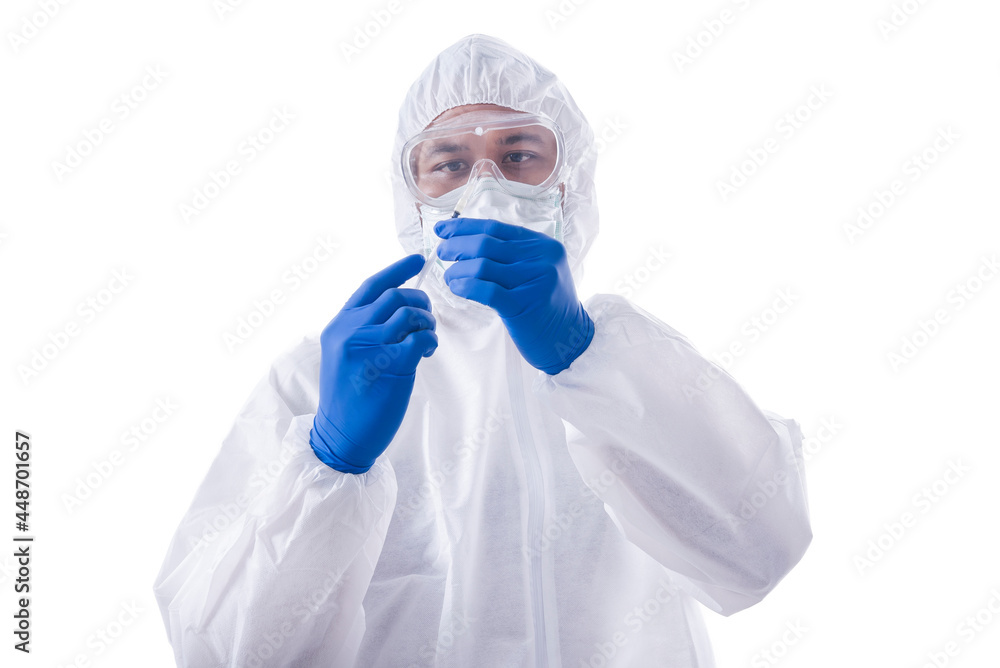 Health worker man with a protective suit and gloves holding syringe Health worker man with a protective suit and gloves holding syringe