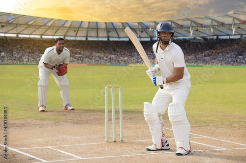 Cricketer batsman at the crease waiting for the ball. photo