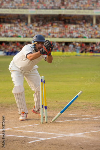  Wicketkeeper catching a throw at the stumps During a match in the stadium