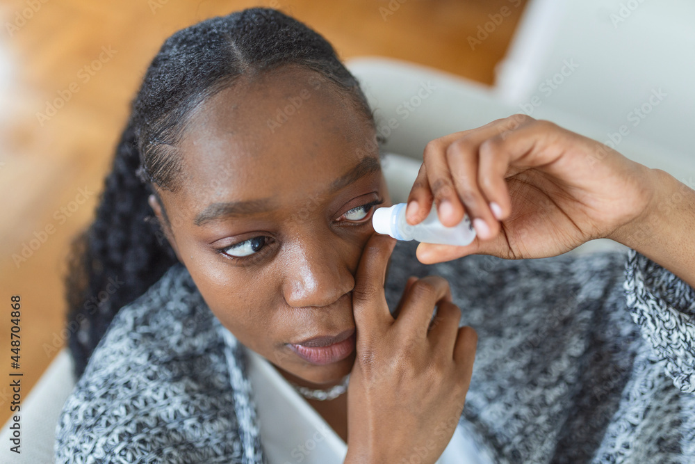 Woman using eye drop, woman dropping eye lubricant to treat dry eye or
