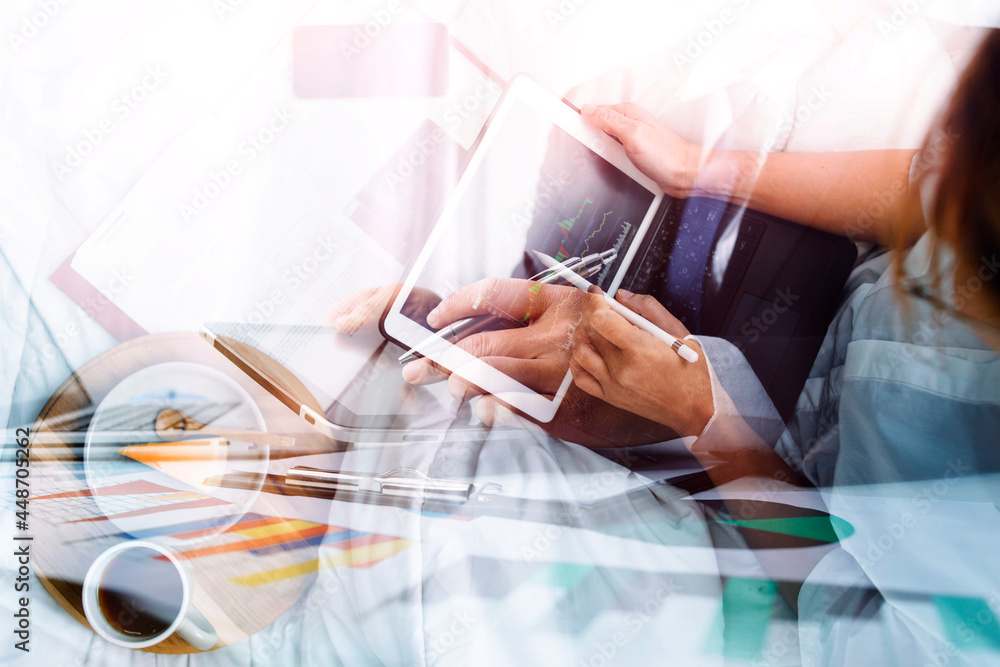 Fototapeta premium Businesswoman working on laptop computer sitting at home with a dog pet and managing her business via home office during Coronavirus or Covid-19 quarantine