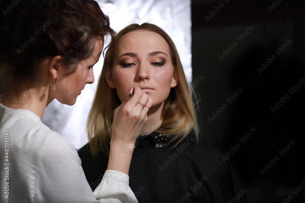 Young girl with a make-up artist Young girl with a make-up artist