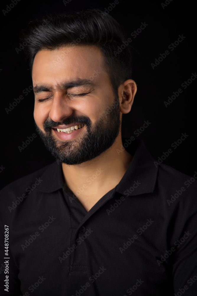 PORTRAIT OF A SMART BEARDED MAN LAUGHING PORTRAIT OF A SMART BEARDED MAN LAUGHING