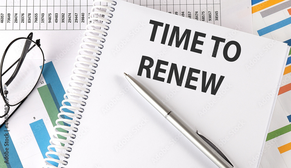 TIME TO RENEW pen and glasses on chart, business concept TIME TO RENEW pen and glasses on chart, business concept