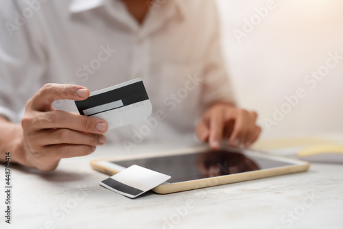 Hands holding plastic credit card and using laptop. Online shopping concept
