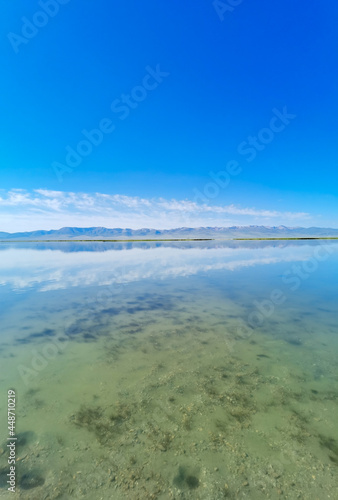 Fototapeta Naklejka Na Ścianę i Meble -  Reflection on Song Kul lake in Kyrgyzstan 