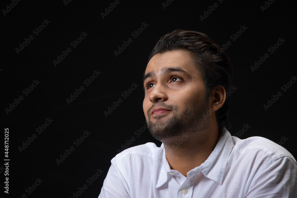 Portrait of a young man smiling while thinking something. Portrait of a young man smiling while thinking something.