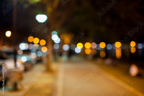 Blurred Street night pedestrians.
