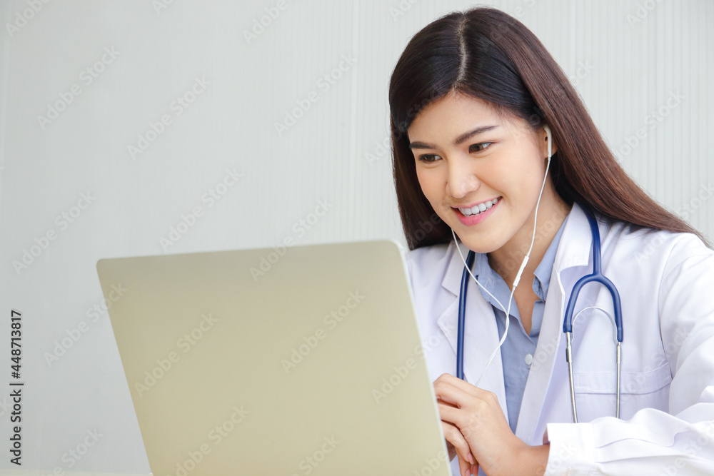 Asian female doctor online video call Check the symptoms with the patient via the Internet. on a laptop computer. The concept is connected to communication through online technology. Asian female doctor online video call Check the symptoms with the patient via the Internet. on a laptop computer. The concept is connected to communication through online technology.