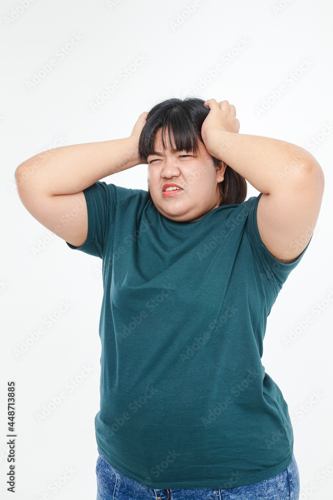 Fat Asian women are overweight. have a headache Use your hands to press against your head to reduce pain. Health problems of obese people. white background Fat Asian women are overweight. have a headache Use your hands to press against your head to reduce pain. Health problems of obese people. white background