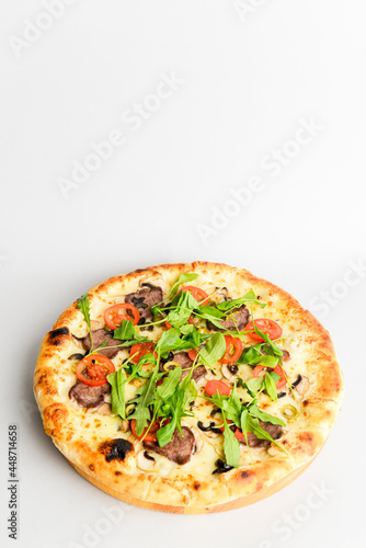 Tasty pizza with meat, mushrooms, tomatoes and basil isolated on white. Copy space banner, vertical banner.