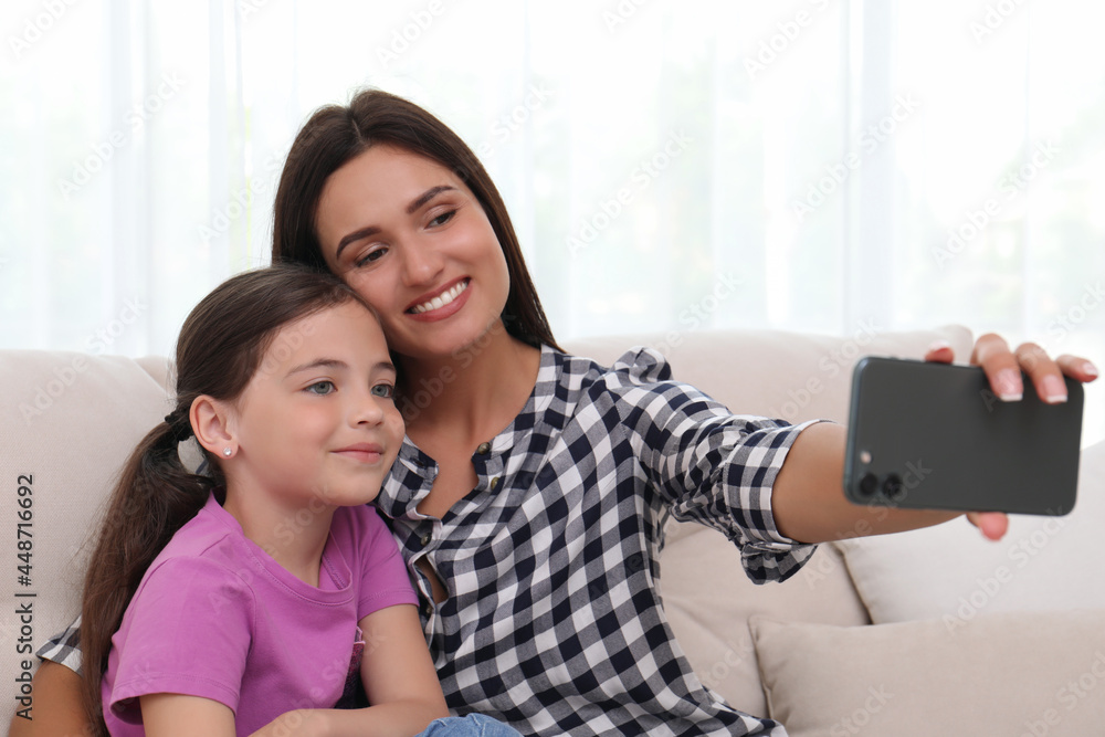 Happy mother and daughter taking selfie together at home. Single parenting Happy mother and daughter taking selfie together at home. Single parenting