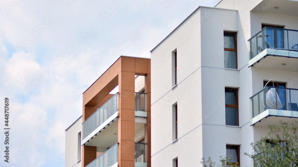 Modern white facade of a residential building with large windows. View of modern designed concrete apartment building. Modern white facade of a residential building with large windows. View of modern designed concrete apartment building.