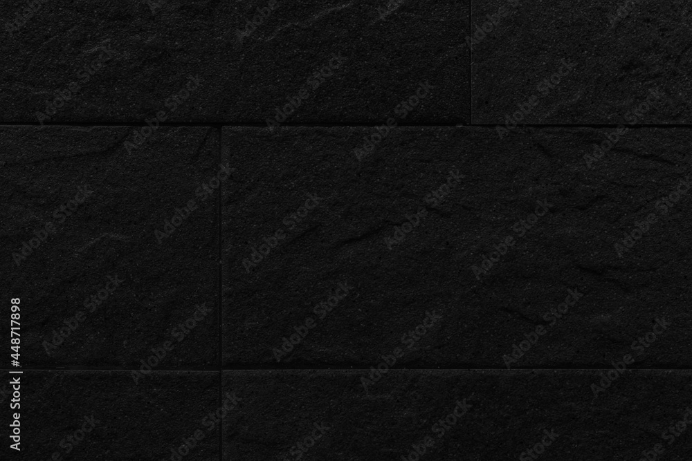 Fototapeta premium Black granite tiled wall with vintage pattern texture and background seamless