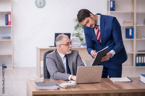 Two male employees working in the office