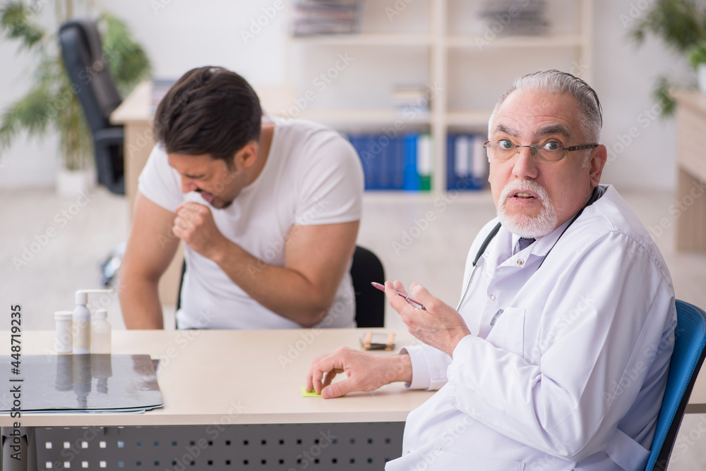Young male patient visiting old male doctor Young male patient visiting old male doctor