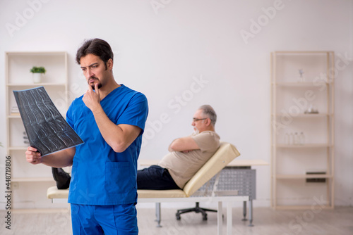 Old male patient visting young male doctor radilogist photo