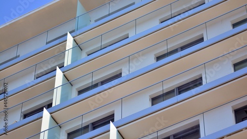 New apartment building with glass balconies. Modern architecture houses by the sea. Large glazing on the facade of the building.