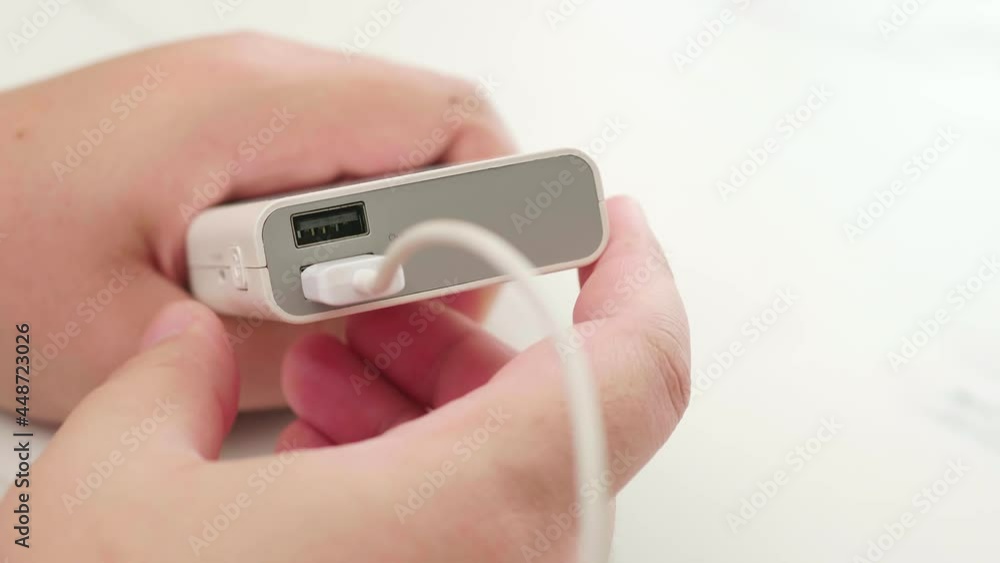 Man connect cable for charging power bank. Technology smart gadget device concept. Man connect cable for charging power bank. Technology smart gadget device concept.