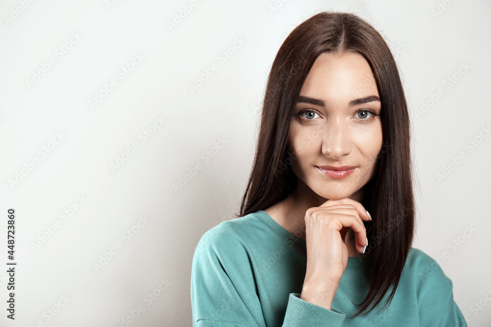 Portrait of pretty young woman with gorgeous chestnut hair on light background, space for text Portrait of pretty young woman with gorgeous chestnut hair on light background, space for text