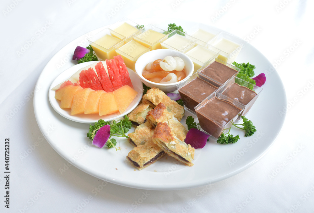 cold sweet dessert platter with pudding, mango, fruits, deep fried red bean paste, jelly, strawberry, watermelon, almond, longan, lychee in white background asian halal menu cold sweet dessert platter with pudding, mango, fruits, deep fried red bean paste, jelly, strawberry, watermelon, almond, longan, lychee in white background asian halal menu