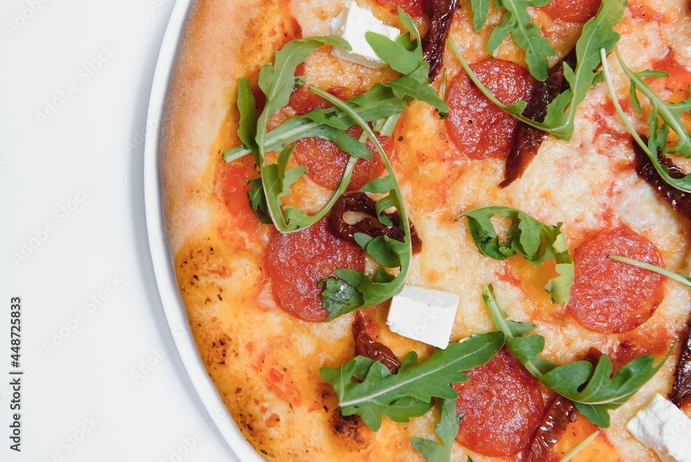 Delicious italian pizza over white background top view Delicious italian pizza over white background top view