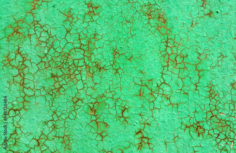 Fototapeta premium Texture of green painted metallic wall cracked and rusty