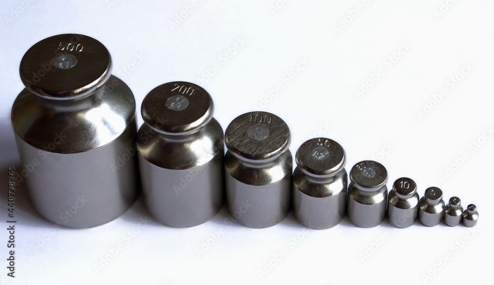 A set of small scales from 1 to 500 grams. They stand in a row from small to large on a white background A set of small scales from 1 to 500 grams. They stand in a row from small to large on a white background
