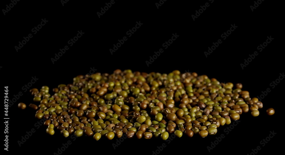 Green mungo beans pile (Vigna radiata) isolated on black background Green mungo beans pile (Vigna radiata) isolated on black background