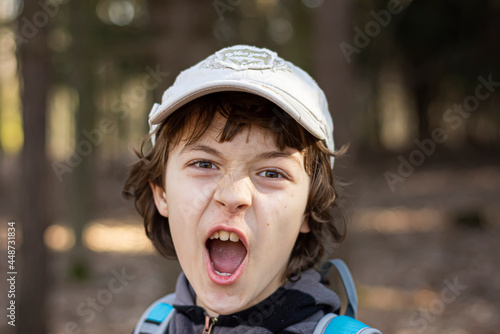 Portrait of screaming boy outdoor.