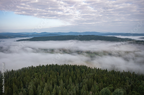 Aerial view on mountains in clouds from drone