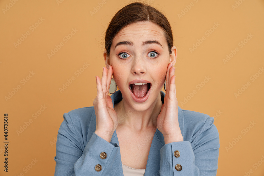 Young ginger excited woman expressing surprise at camera Young ginger excited woman expressing surprise at camera