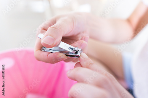 Close up Woman cutting finger nails using nail clipper or Manicure by herself