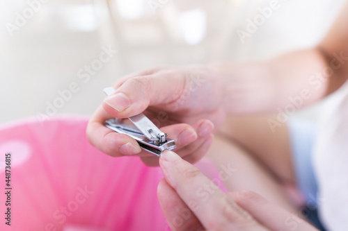 Close up Woman cutting finger nails using nail clipper or Manicure by herself
