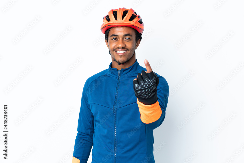 Young cyclist man with braids over isolated background doing coming gesture