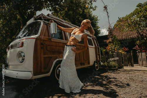 Beach Lifestyle Surfer Girl next to Vintage Surf Van