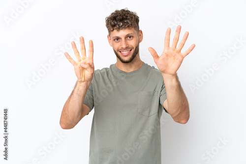 Young caucasian handsome man isolated on white background counting nine with fingers © luismolinero
