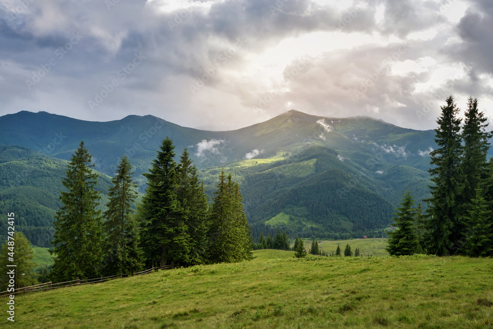 Wonderful summer panorama with mountains. Rain Clouds Above Mountains. Location place Carpathian mountains, Ukraine, Europe.
