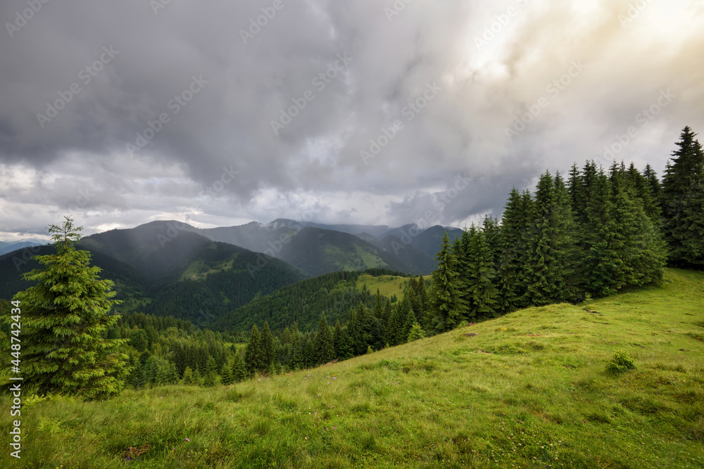 Wonderful summer panorama with mountains. A thunderstorm is coming. Rain Clouds Above Mountains. Location place Carpathian mountains, Ukraine, Europe.