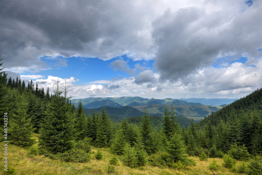 Wonderful summer panorama with mountains. Rain Clouds above Mountains. Location place Carpathian mountains, Ukraine, Europe.