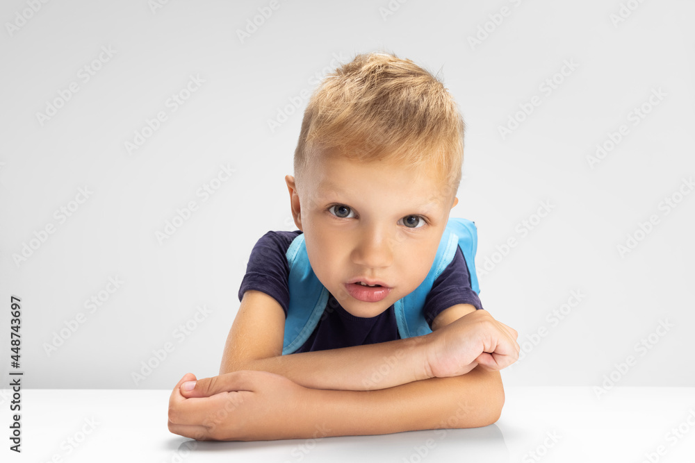 Close-up Caucasian preschool boy isolated on white studio background. Copyspace for ad. Childhood, education, emotion concept Close-up Caucasian preschool boy isolated on white studio background. Copyspace for ad. Childhood, education, emotion concept