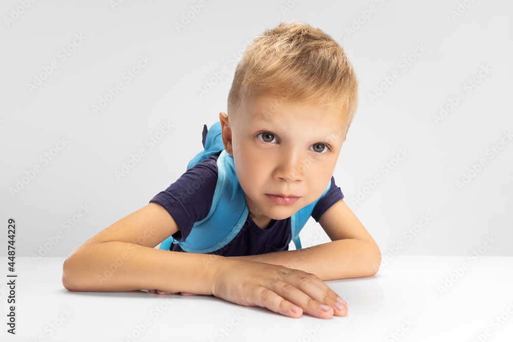 Close-up Caucasian preschool boy isolated on white studio background. Copyspace for ad. Childhood, education, emotion concept Close-up Caucasian preschool boy isolated on white studio background. Copyspace for ad. Childhood, education, emotion concept